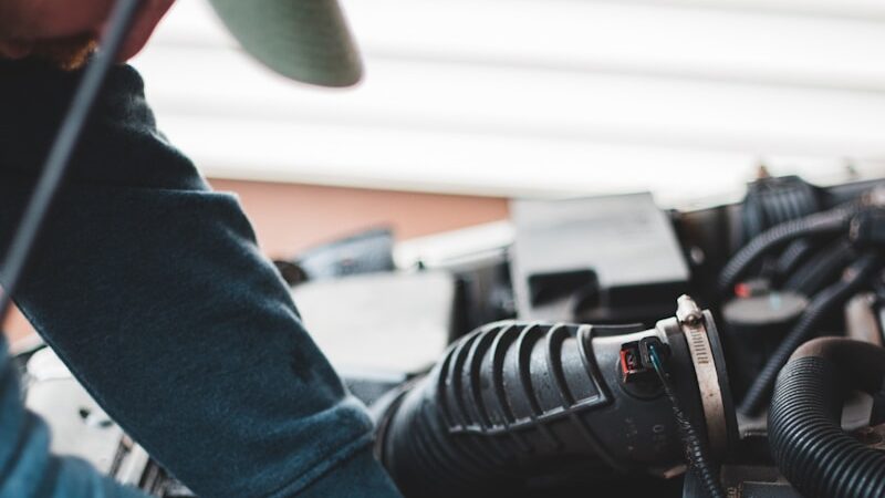 person in blue denim jeans and black and white adidas sneakers riding on black motorcycle